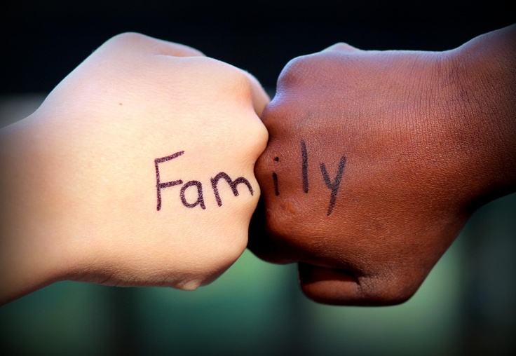child hands touching with family written across them